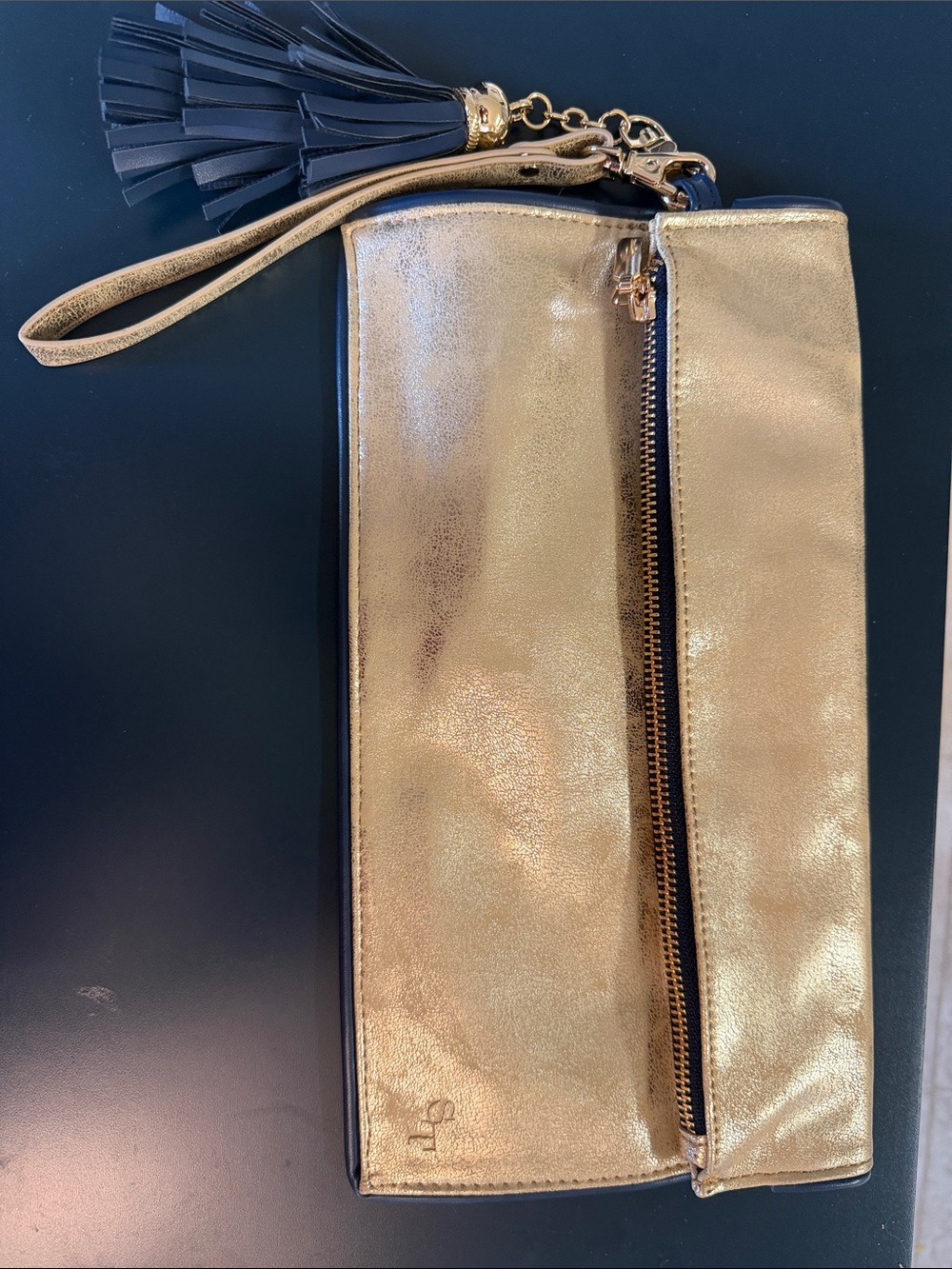 Southern Tide Mate Gold Metallic Wristlet Clutch with Tassel with navy tassel.